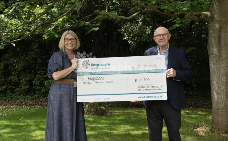 David Bassett presenting a £15,000 donation from the League of Friends of Exmouth Hospital to Ann Rhys of Hospiscare